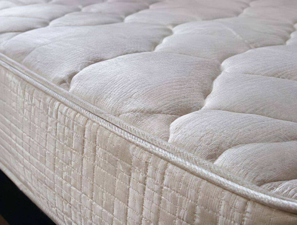 Close-up of a quilted brand-new mattress surface and stitched edge